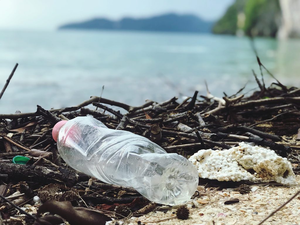 Empty plastic bottle littered on a beach.