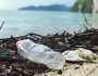 Empty plastic bottle littered on a beach.