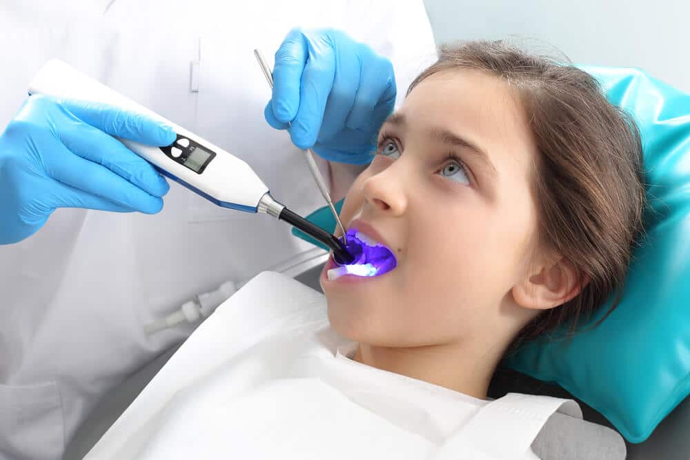 Illustration of a Canadian girl at the dentist's office undergoing a dental procedure amid calls for mercury-free dentistry in Canada by Friends of the Earth.