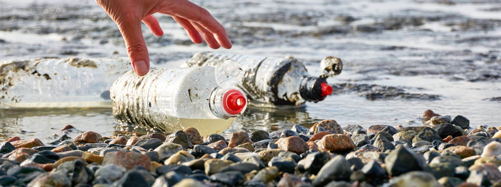 2-Plastic-Bottles-on-a-Beach-with-Red-Caps